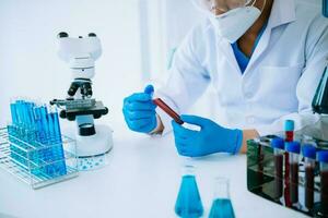 Scientist mixing chemical liquids in the chemistry lab. Researcher working in the chemical laboratory photo