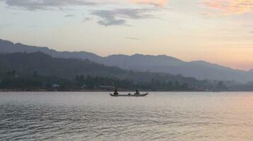 Fisherman Silhouette on His Boat photo