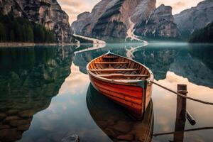 Wooden rowing boat on scenic lake with mountains in background. photo