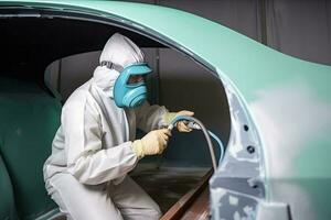 Car painter in protective clothes paints automobile with paint in chamber workshop. Generative AI photo