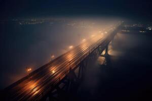 The foggy bridge with a street light on the side. The night bridge covered in the fog. photo