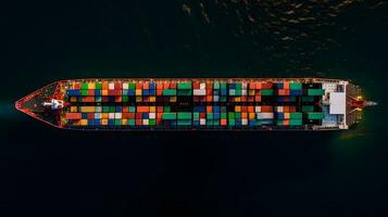 Aerial top down view of a large container cargo ship in motion over open ocean. photo