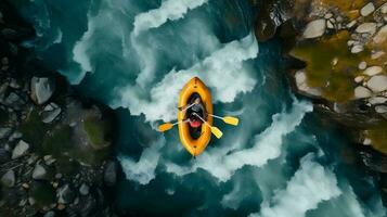 Aerial top view Extreme sport kayak sails mountain river with sun light. Rafting, whitewater kayaking. photo