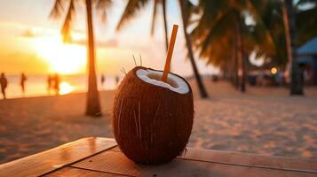 Coconut drink with straw on the beach. photo