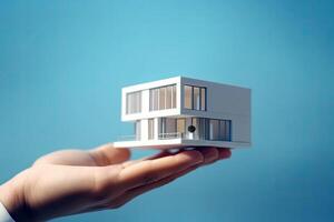 Close up of hand holding model house for represent to client, business idea concept, financial money management, building architecture, with . photo