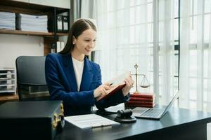 .Female judge in a courtroom on wooden table and Counselor or Male lawyer working in office. justice and law concept photo