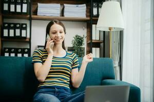 Caucasian businesswoman working in the office with working notepad, tablet and laptop documents on sofa in home office photo