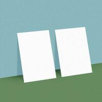 Empty paper sheets on blue and green background for making mock up.Minimal mock up template. photo