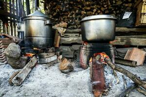 rustic kitchen, with natural wood-fired stove in country photo