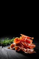 Spanish Jamon ham, prosciutto closeup isolated on black background copy space, photo