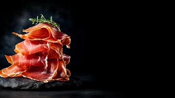 Spanish Jamon ham, prosciutto closeup isolated on black background copy space, photo