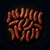 Grilled sausages during the preparation closeup , copy spaceisolated on black background, photo