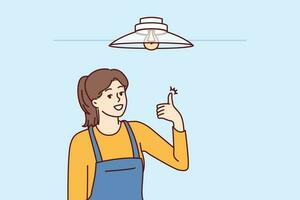 Woman electrician showing thumbs up after fixing chandelier or replacing light bulb under ceiling. Girl in overalls works as electrician efficiently performing tasks of setting up electricity vector