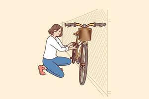 Woman parks bicycle near fence after returning from work on environmentally friendly transport. Concept caring for nature and rejection of cars with internal combustion engine in favor of bicycle vector