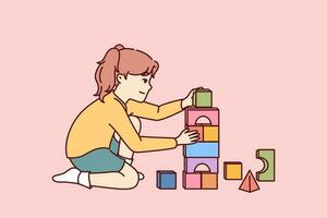 Little girl plays sitting on floor and builds toy bricks tower for concept of educational games for children. Child uses plastic or wooden toy bricks enjoying creation of pyramids. vector