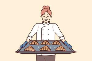 mujer panadero sostiene bandeja de croissants preparando Fresco pasteles para rebaja en propio panadería. niña cocinar y propietario de panadería con sonrisa demuestra delicioso dulce bollos para desayuno o almuerzo vector