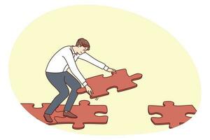 Man connecting jigsaw puzzle making way vector