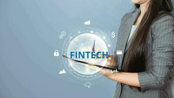 Businesswoman touching on mobile and Computer Fintech. Internet of Things IoT technology concept. Digital money transfer. Financial technology. photo