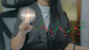 Businesswoman pressing the trading graph button on virtual screen. Trading concept. photo