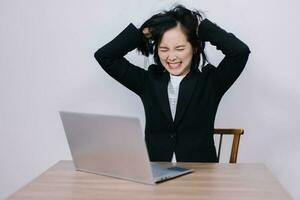 Young beautiful business woman stressed from office work Use your hands to ruffle your hair until it's a mess. photo