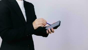 Businessman using digital smart phone with modern mobile phone. New technologies for success workflow concept. photo