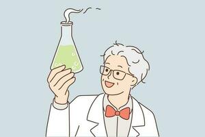 Laboratory assistant in white coat holds flask with green fuming liquid while examining chemical reaction of reagent. Gray-haired chemist or scientist discovering new drug to fight terrible disease vector