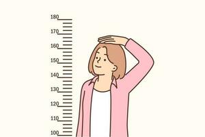 Teenage girl measures height standing near marks on wall, wanting to become tall and have attractive appearance. Girl with short stature dreams of growing up and measures progress. vector