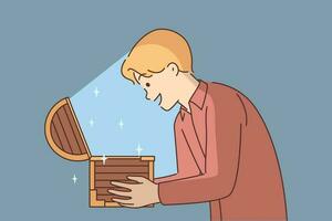 Man with open chest filled with treasures or jewels for concept of lucky find and luck. Delighted guy holds wooden chest with rays of light illuminating face and shouts WOW sees contents vector