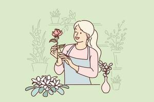 Woman florist works in flower shop composing beautiful festive bouquets for customers. Happy girl in apron makes career as seller or florist standing behind counter and holding rose in hand vector