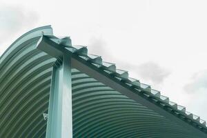 Texture of metal sheet roof. Curved metal roofing panels view from below photo