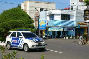 Wonosobo, Indonesia - April 5, 2023 - Indonesian police patrol vehicles are parked at the crossroads photo