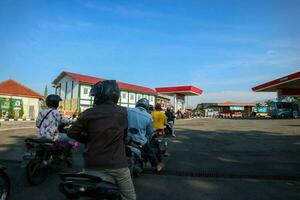 Wonosobo, Indonesia - April 5, 2023 - Queue of vehicles refueling at Pertamina Gas Station photo