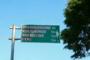 Green road sign or street sign for traffic direction information board at Wonosobo square. photo