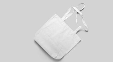 An isolated view of the white Tote bag on an grey background. photo