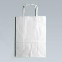 A classic white tote bag is the only item in focus against a white background. photo