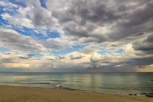 Stunning vast seascape from the seashore with cloudy sky photo
