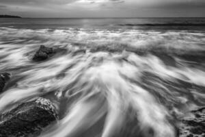 Stunning black and white long exposure seascape at cloudy day. photo