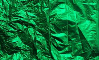 Wrinkled green plastic wrap texture for background. abstract paper foil wallpaper photo