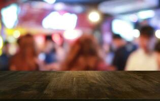 vacío oscuro de madera mesa en frente de resumen borroso bokeh antecedentes de restaurante . lata ser usado para monitor o montaje tu productos.mock arriba para espacio. foto