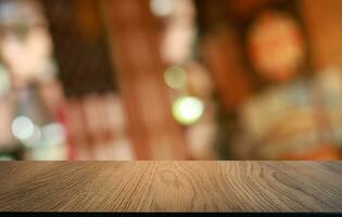 Empty wooden table in front of abstract blurred background of coffee shop . can be used for display or montage your products.Mock up for display of product photo