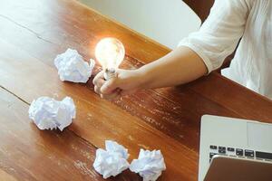 Idea of business person holding light bulb concept creativity with bulbs. photo