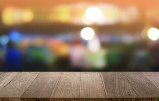 Empty dark wooden table in front of abstract blurred bokeh background of restaurant . can be used for display or montage your products.Mock up for space. photo