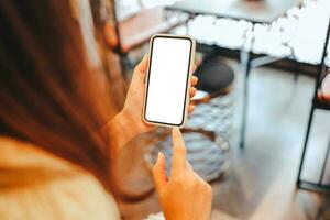 Women's hands holding cell telephone blank copy space screen. smartphone with blank white screen isolated on white background . smart phone with technology concept photo