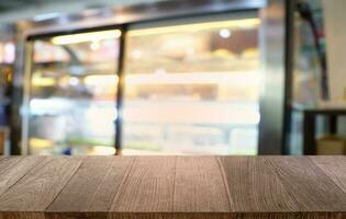 Empty dark wooden table in front of abstract blurred bokeh background of restaurant . can be used for display or montage your products.Mock up for space. photo