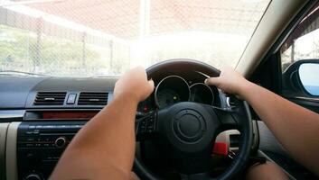 Man driving with both hands on steering wheel selective focus. safety driving car photo