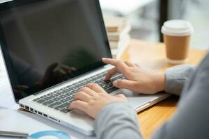 Business Woman working by using laptop computer Hands typing on a keyboard. Professional investor working new start up project. business planning in office. Technology business Concept photo