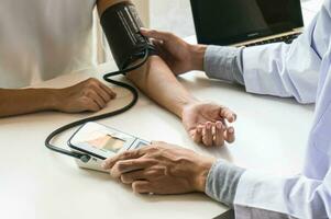 Doctor healthcare. Professional medical doctor in white uniform gown coat interview consulting patient reassuring his male patient helping hand photo