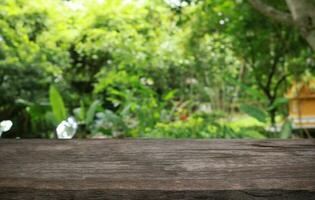 Empty wood table top and blur of out door garden background Empty wooden table space for text marketing promotion. blank wood table copy space photo