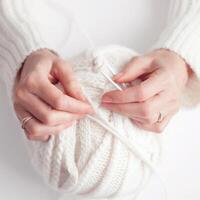 Women's hands close-up, knitting, Crochet.top view on pure white background.AI generated.artificial intelligence photo