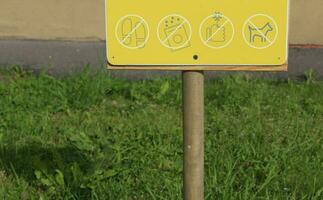 Many prohibition signs on one poster in a summer park. photo